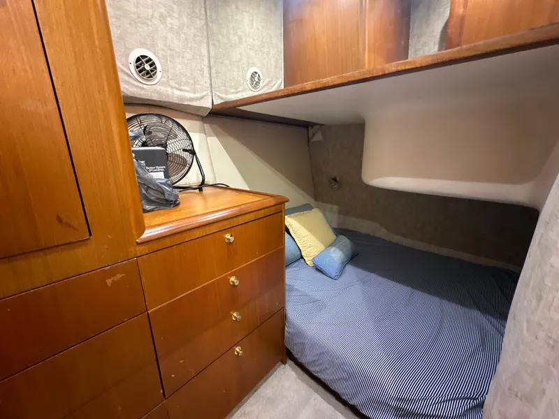 Slide: The Image of 1999 Ocean 45 Super Sport yacht cabin with wooden cabinetry and cozy bed. - 19