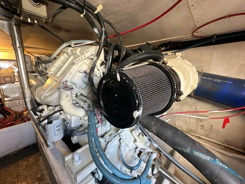 Slide: The Image of 1999 Ocean 45 Super Sport engine compartment with visible air filter and hoses. - 24