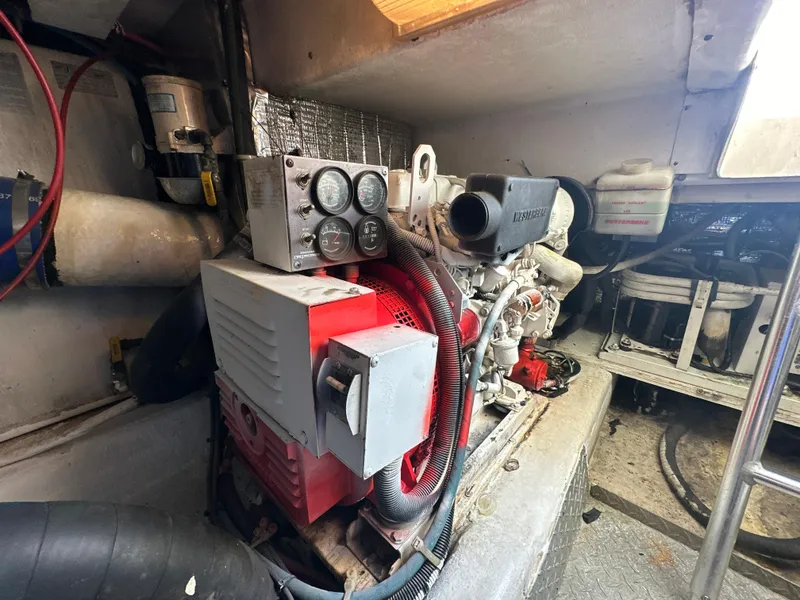 Slide: The Image of Engine room of a 1999 Ocean 45 Super Sport boat showing machinery. - 25