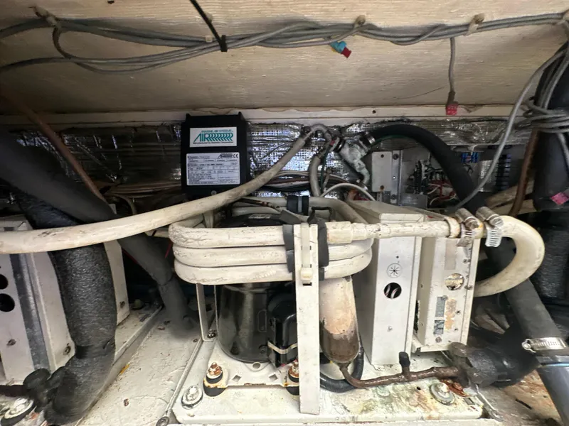 Slide: The Image of Engine compartment of a 1999 Ocean 45 Super Sport boat showing mechanical components. - 26