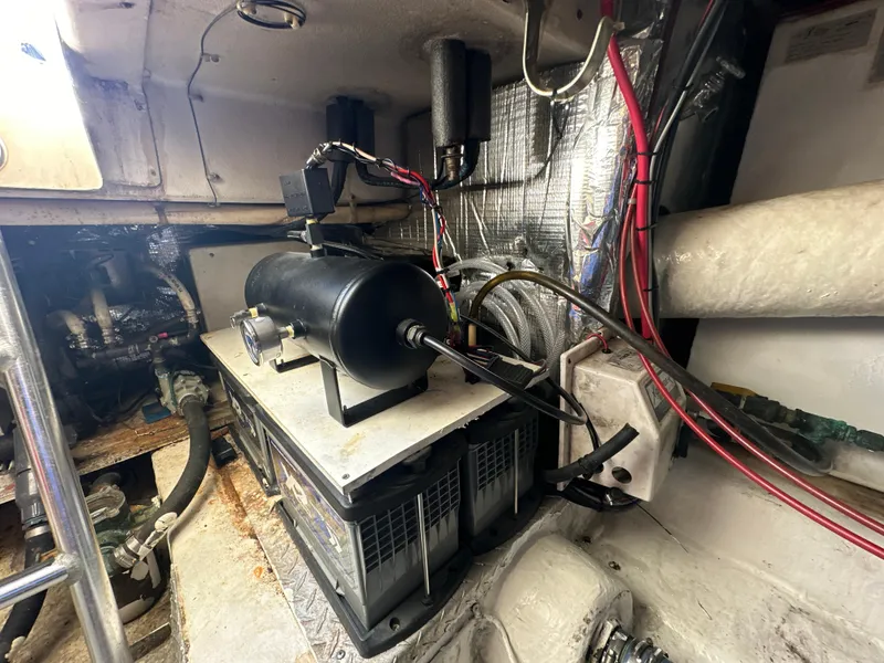 Slide: The Image of Engine room of a 1999 Ocean 45 Super Sport boat with mechanical components. - 27