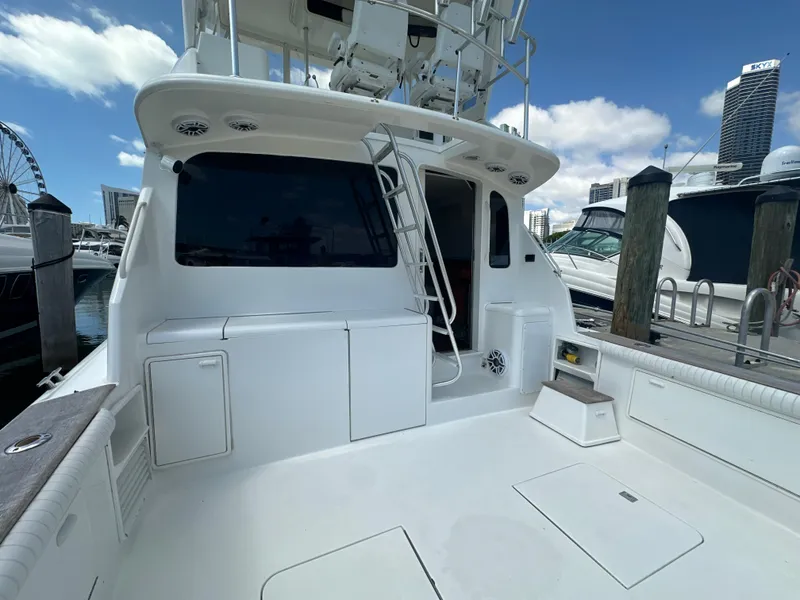 Slide: The Image of 1999 Ocean 45 Super Sport yacht docked at marina, rear deck view. - 4