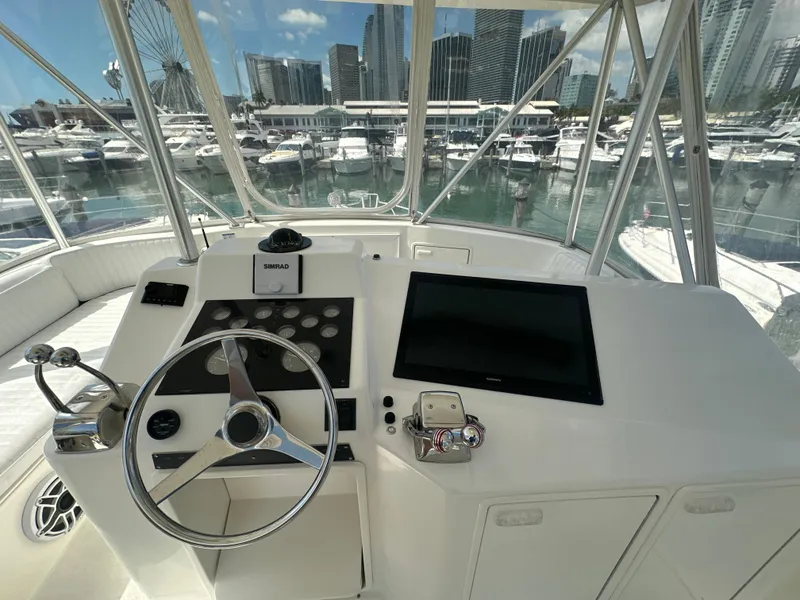 Slide: The Image of Helm of a 1999 Ocean 45 Super Sport yacht with marina view. - 6