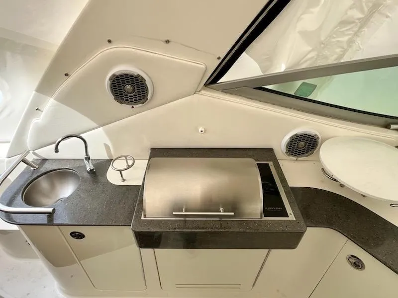 Slide: The Image of Outdoor kitchenette on 2012 Sea Ray 330 Sundancer with sink, grill, and speakers. - 11