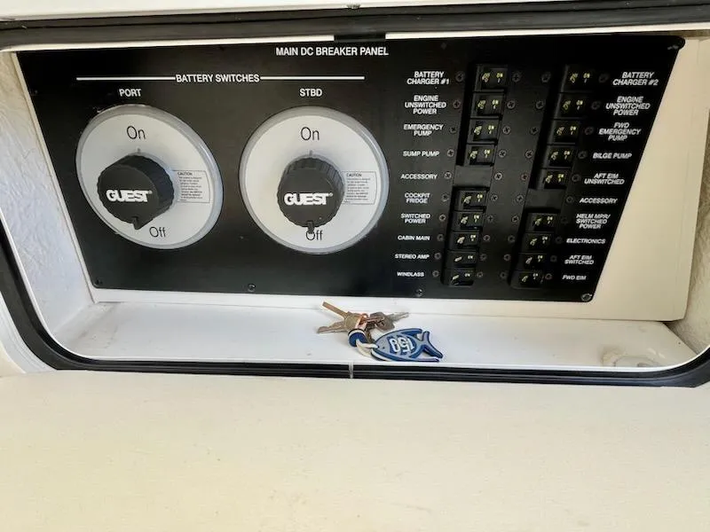 Slide: The Image of Main DC breaker panel on 2012 Sea Ray 330 Sundancer with keys placed on it. - 15