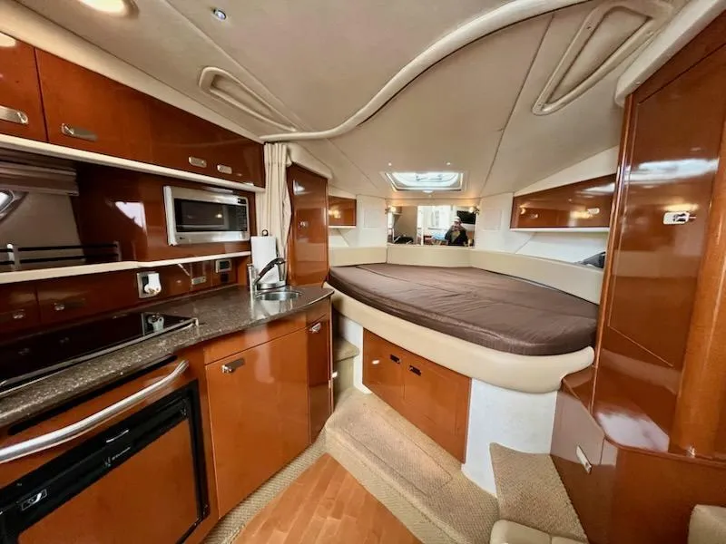 Slide: The Image of Interior of 2012 Sea Ray 330 Sundancer yacht with kitchen and bed. - 16