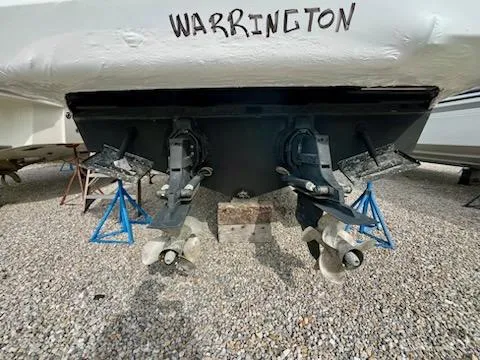 Slide: The Image of 2012 Sea Ray 330 Sundancer boat on stands, rear view with propellers visible. - 42