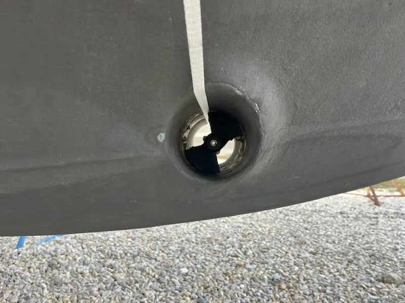 Slide: The Image of Close-up of a 2012 Sea Ray 330 Sundancer's bow thruster on a gravel surface. - 44