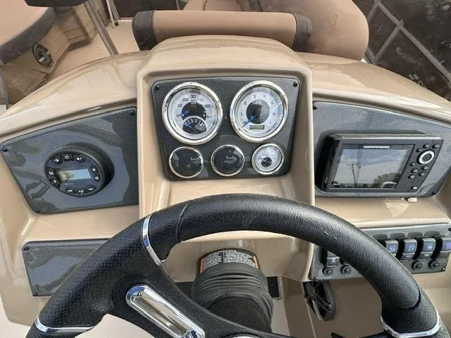 Slide: The Image of 2024 Starcraft EX 22 FD boat dashboard with gauges and navigation system. - 7