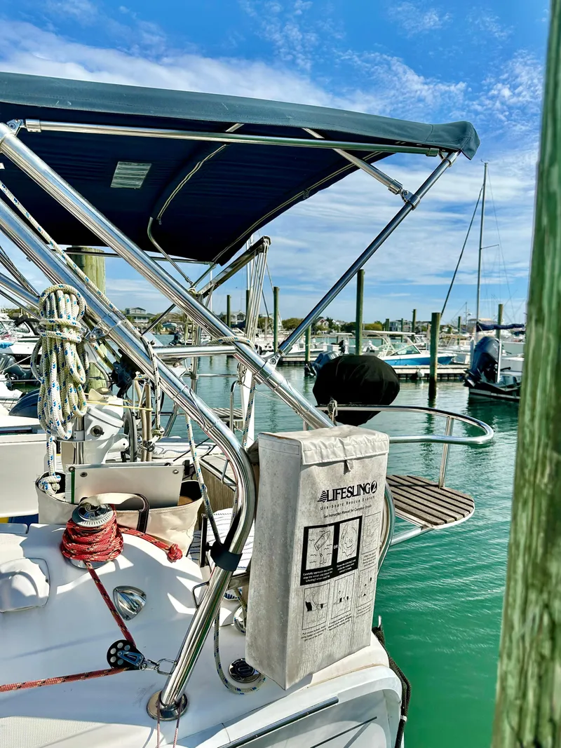 Slide: The Image of Sailboat docked at marina, Hunter 33 model, 2014, with clear blue sky. - 10