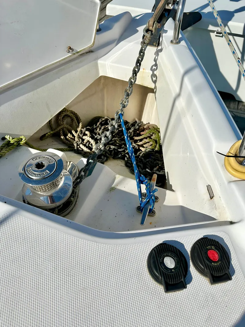 Slide: The Image of Anchor chain and winch on a 2014 Hunter 33 sailboat deck. - 11