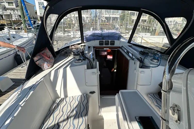 Slide: The Image of Cockpit of 2014 Hunter 33 sailboat with seating and navigation equipment. - 17