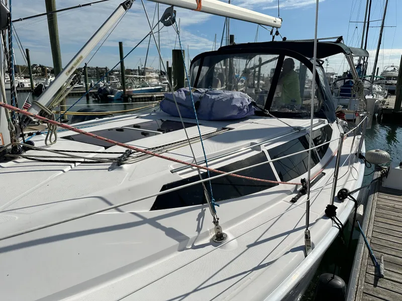 Slide: The Image of 2014 Hunter 33 sailboat docked at marina under clear blue sky. - 2