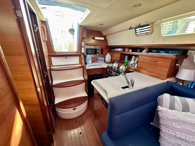 Slide: The Image of Interior of a 2014 Hunter 33 sailboat with modern kitchen and seating area. - 23