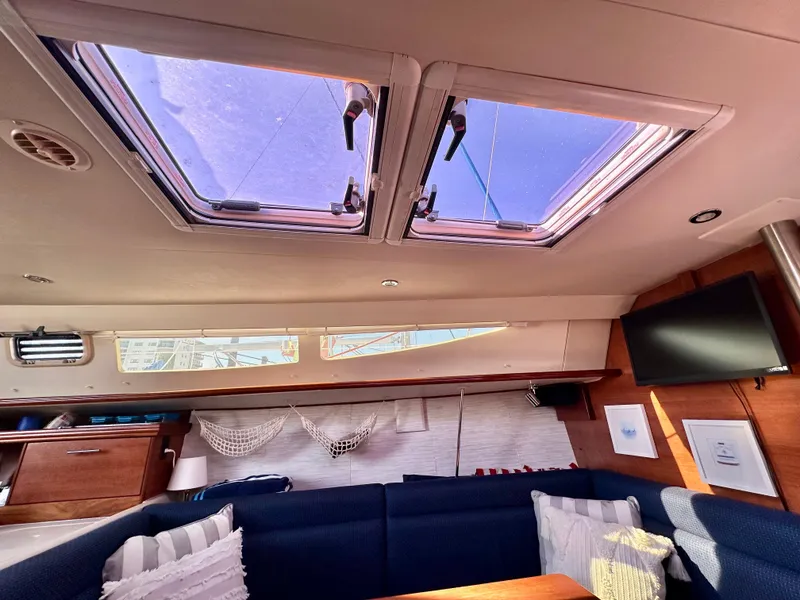 Slide: The Image of Interior of 2014 Hunter 33 sailboat with skylights, seating, and TV. - 25