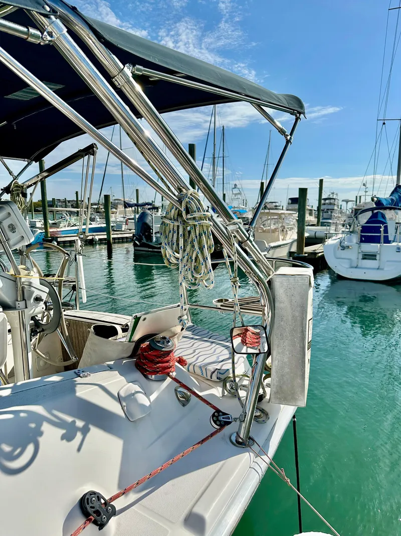 Slide: The Image of 2014 Hunter 33 sailboat docked at marina under clear blue sky. - 4