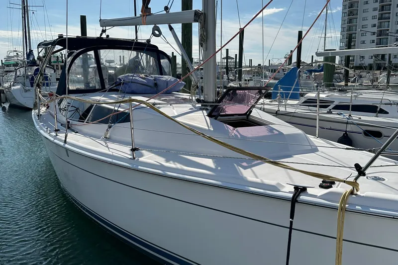 Slide: The Image of 2014 Hunter 33 sailboat docked in marina, clear sky, calm water. - 7