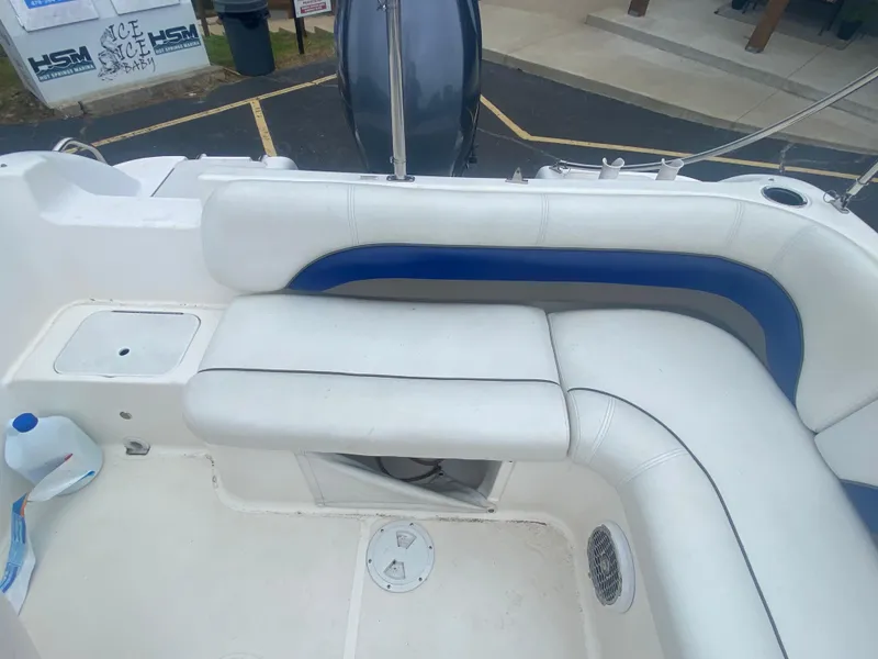 Slide: The Image of 2012 Hurricane SunDeck Sport 201 OB boat interior with white and blue seating. - 11