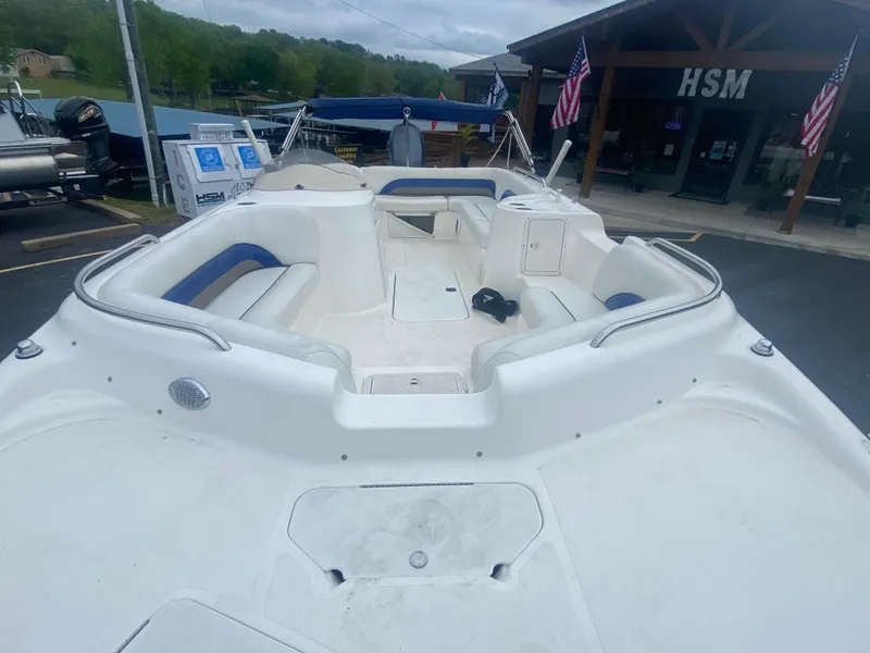 Slide: The Image of 2012 Hurricane SunDeck Sport 201 OB boat with spacious seating and storage, docked near HSM building. - 12