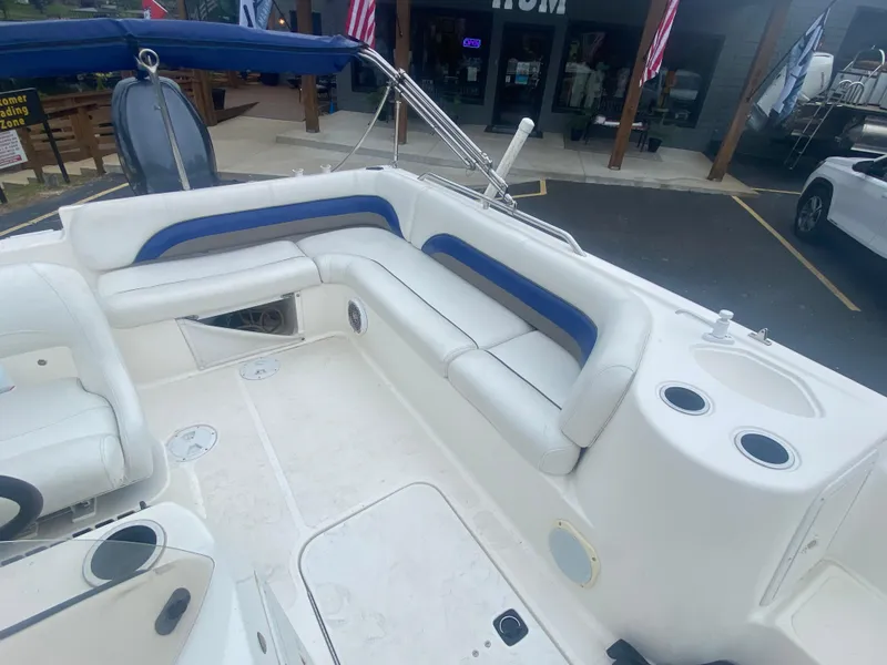 Slide: The Image of 2012 Hurricane SunDeck Sport 201 OB boat interior with white and blue seating. - 17