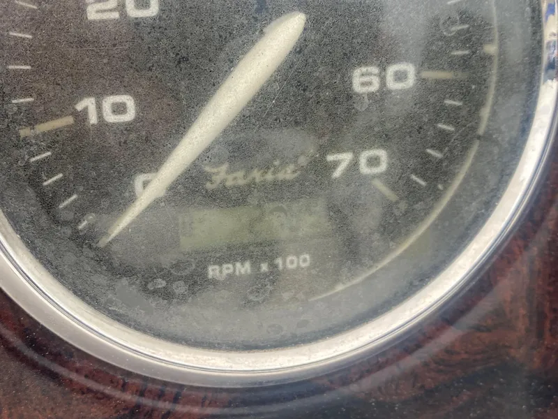 Slide: The Image of Close-up of a dusty tachometer on a 2012 Hurricane SunDeck Sport 201 OB boat. - 19