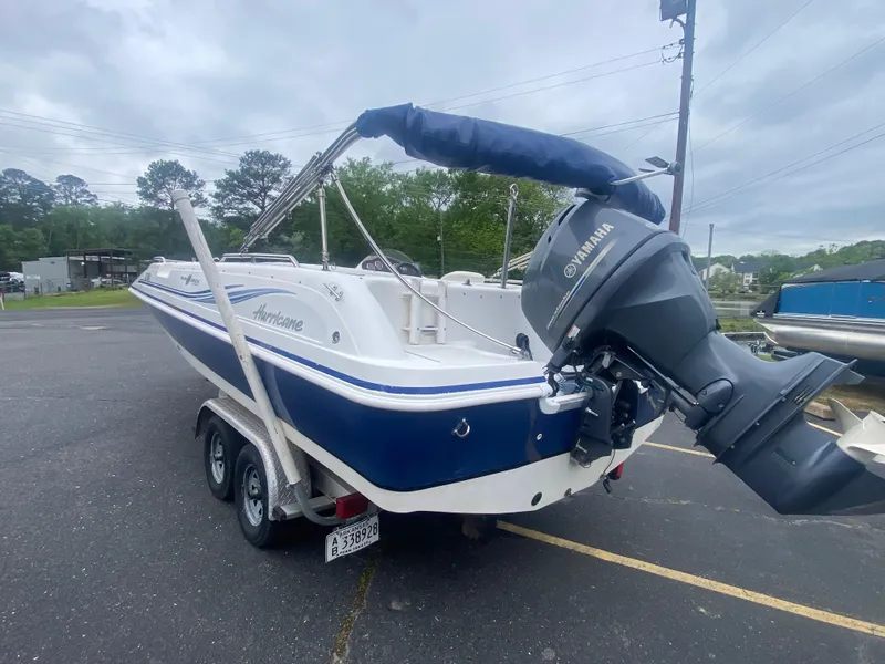 Slide: The Image of 2012 Hurricane SunDeck Sport 201 OB boat with Yamaha outboard motor on trailer. - 4
