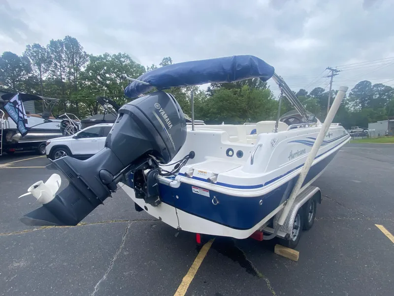 Slide: The Image of 2012 Hurricane SunDeck Sport 201 OB boat with Yamaha outboard motor in parking lot. - 5