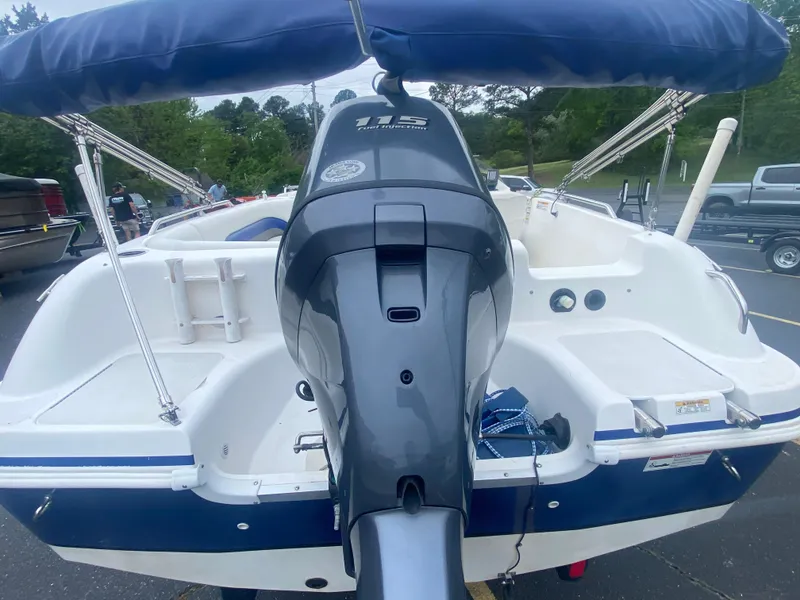 Slide: The Image of 2012 Hurricane SunDeck Sport 201 OB boat with outboard motor in parking lot. - 6