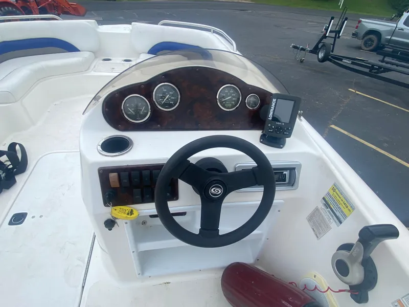 Slide: The Image of 2012 Hurricane SunDeck Sport 201 OB boat dashboard with steering wheel and gauges. - 7