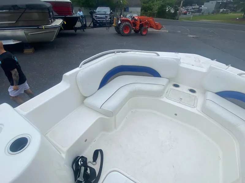 Slide: The Image of 2012 Hurricane SunDeck Sport 201 OB boat interior with white and blue seating. - 8