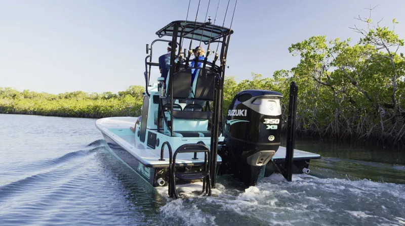 Slide: The Image of 2025 Shallow Sport 25 X3 boat with Suzuki 350 engine navigating through water. - 3