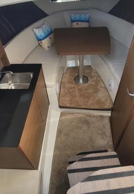 Slide: The Image of 2020 Jeanneau Leader 9.0 WA cabin interior with kitchenette and dining area. - 2