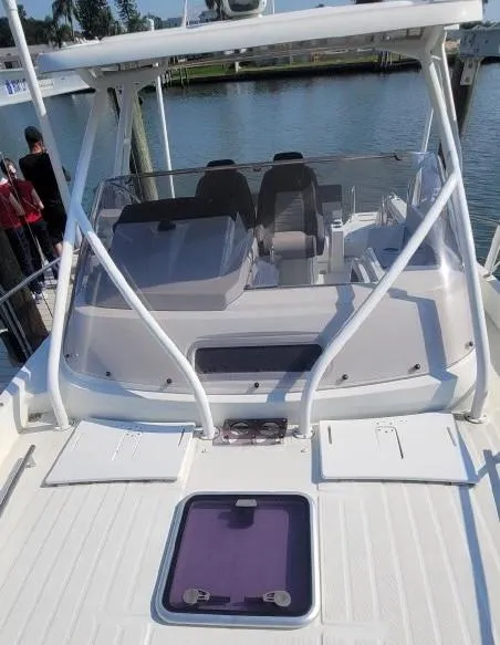 Slide: The Image of 2020 Jeanneau Leader 9.0 WA boat with dual seats and windshield docked by the water. - 5