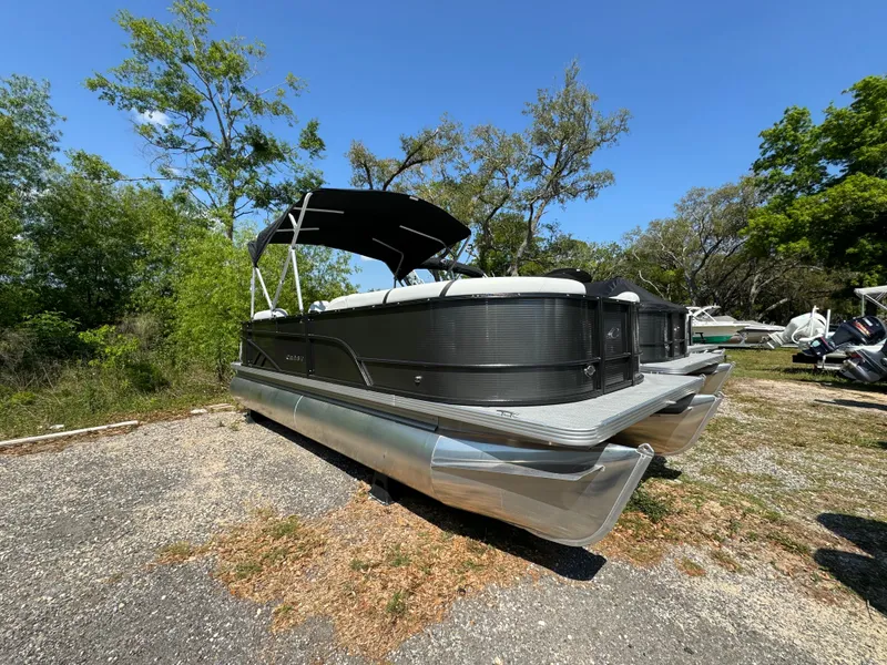 Slide: The Image of 2024 Crest Classic LX 220 pontoon boat on a sunny day. - 0