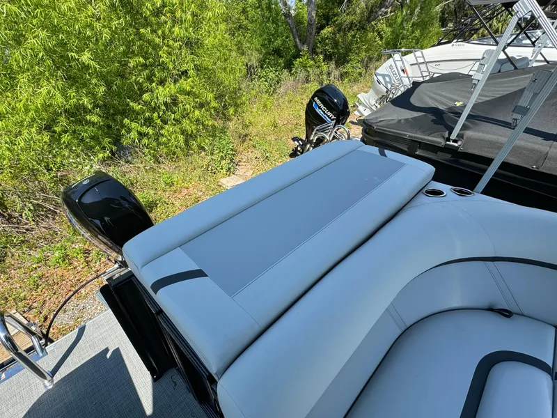 Slide: The Image of 2024 Crest Classic LX 220 boat with rear seating and outboard motor. - 10