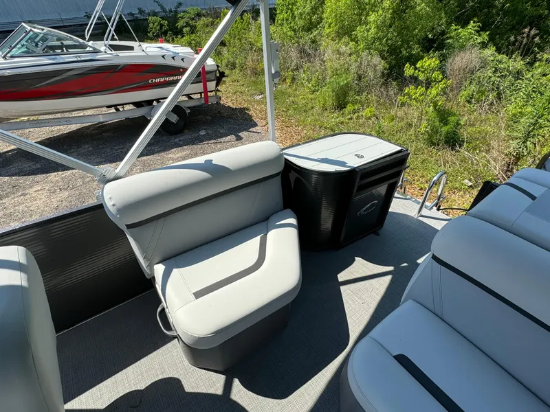 Slide: The Image of 2024 Crest Classic LX 220 pontoon boat interior with seating and storage. - 11