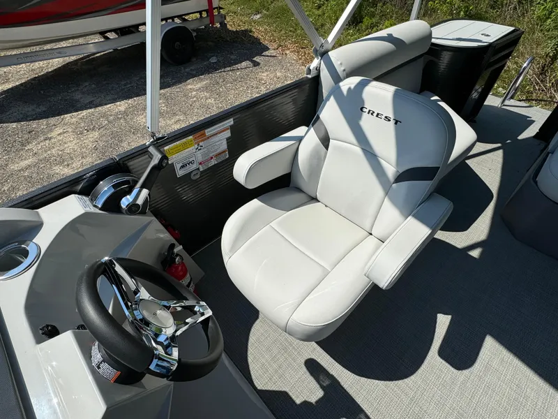 Slide: The Image of Captain's chair and helm of 2024 Crest Classic LX 220 pontoon boat. - 13