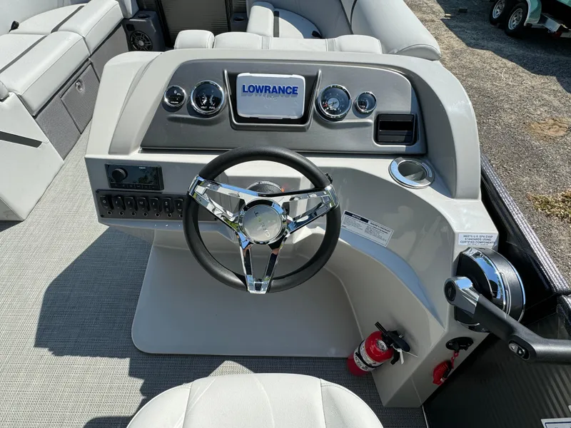 Slide: The Image of 2024 Crest Classic LX 220 boat dashboard with Lowrance display and steering wheel. - 14