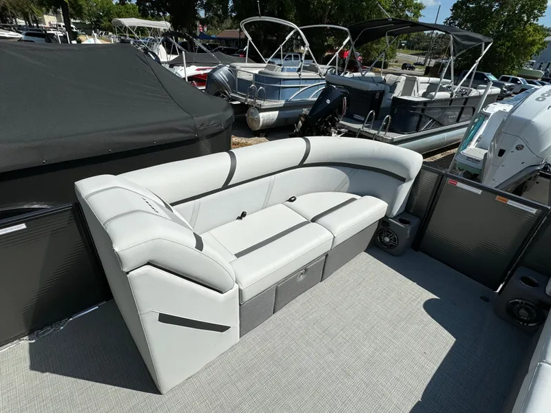Slide: The Image of 2024 Crest Classic LX 220 pontoon boat with spacious seating area. - 16