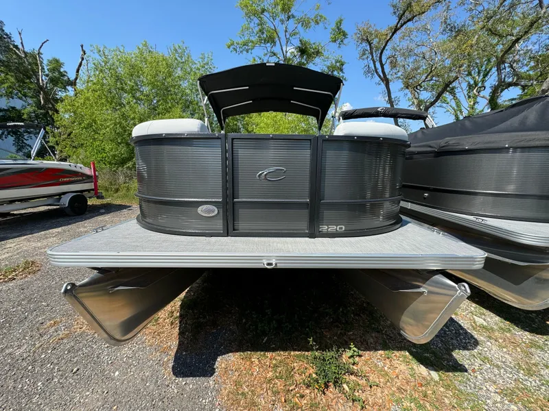 Slide: The Image of 2024 Crest Classic LX 220 pontoon boat in outdoor storage. - 3
