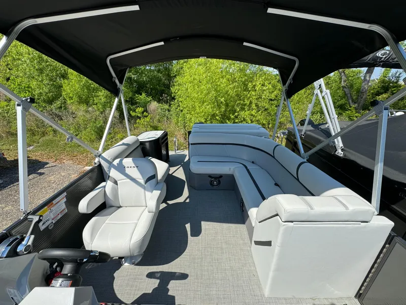 Slide: The Image of 2024 Crest Classic LX 220 pontoon boat with spacious seating and canopy. - 7