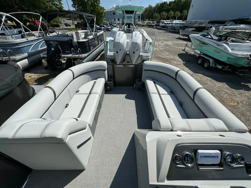Slide: The Image of 2024 Crest Classic LX 220 pontoon boat interior with spacious seating and modern dashboard. - 8