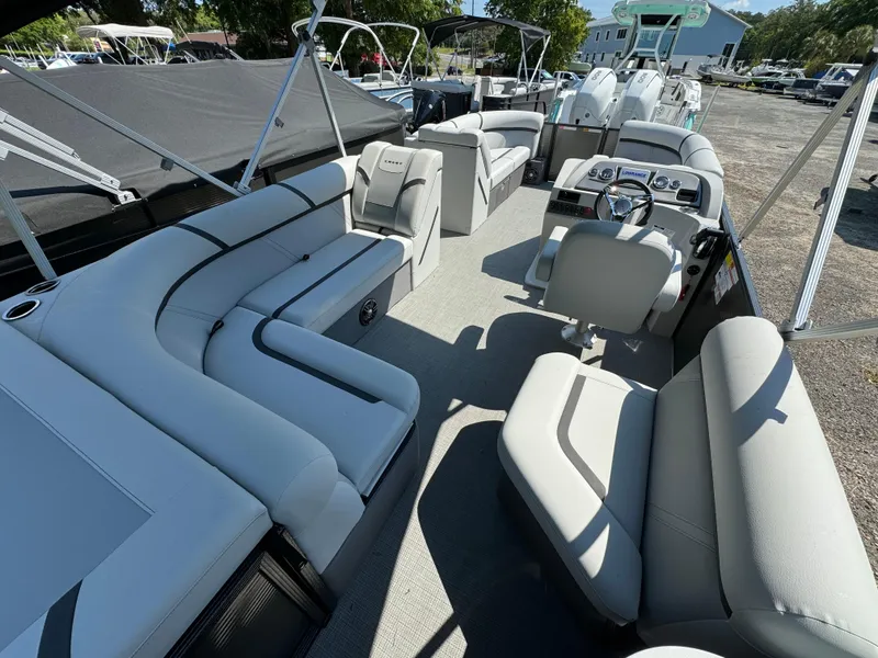 Slide: The Image of 2024 Crest Classic LX 220 pontoon boat with spacious seating and modern design. - 9