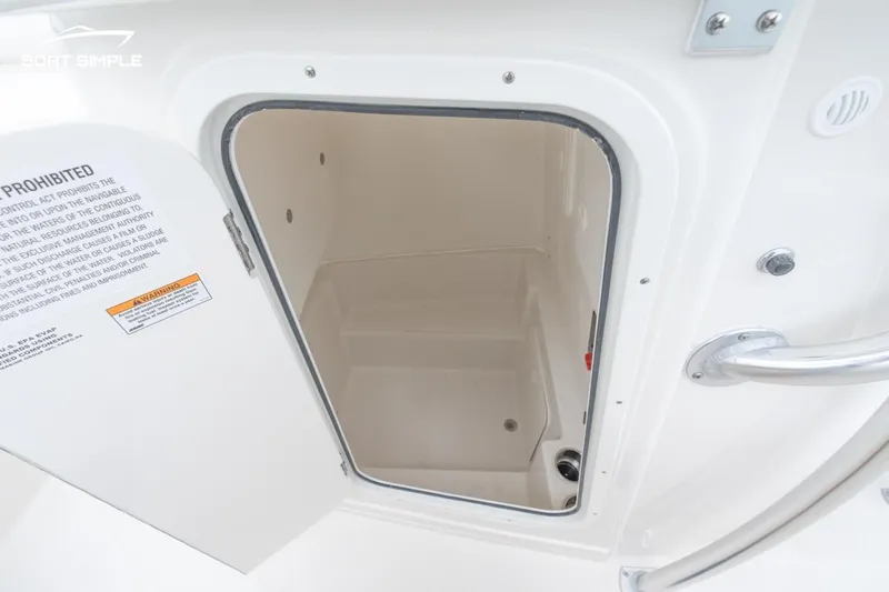 Slide: The Image of 2024 Sailfish 242 CC boat storage compartment with open door. - 10