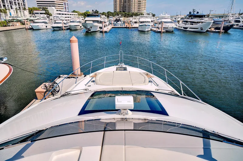 Slide: The Image of 2017 Sunseeker 68 Sport Yacht docked at a marina with other luxury boats. - 10