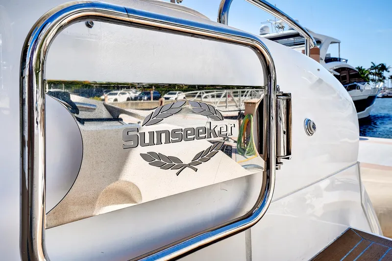 Slide: The Image of 2017 Sunseeker 68 Sport Yacht logo on a polished metal surface. - 11