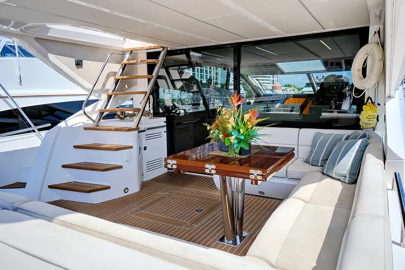 Slide: The Image of Luxurious 2017 Sunseeker 68 Sport Yacht interior with elegant seating and wooden table. - 12