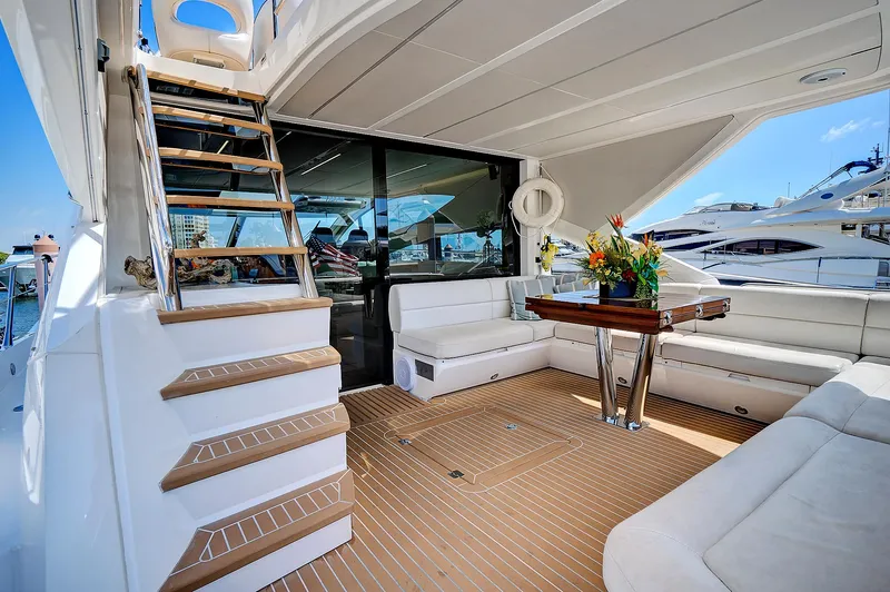 Slide: The Image of 2017 Sunseeker 68 Sport Yacht deck with seating area and table, featuring modern design. - 13