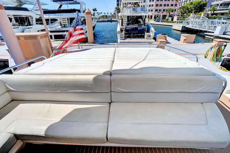 Slide: The Image of Sunseeker 68 Sport Yacht 2017 rear deck with cushioned seating and marina view. - 15