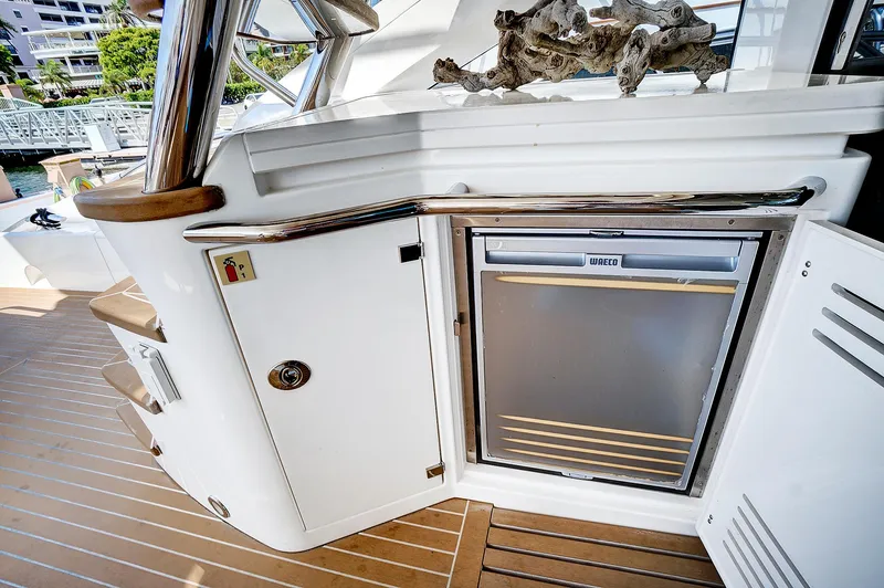 Slide: The Image of 2017 Sunseeker 68 Sport Yacht deck with built-in refrigerator and storage compartments. - 16